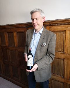 Stuart George with a bottle of Château Mouton Rothschild 1945