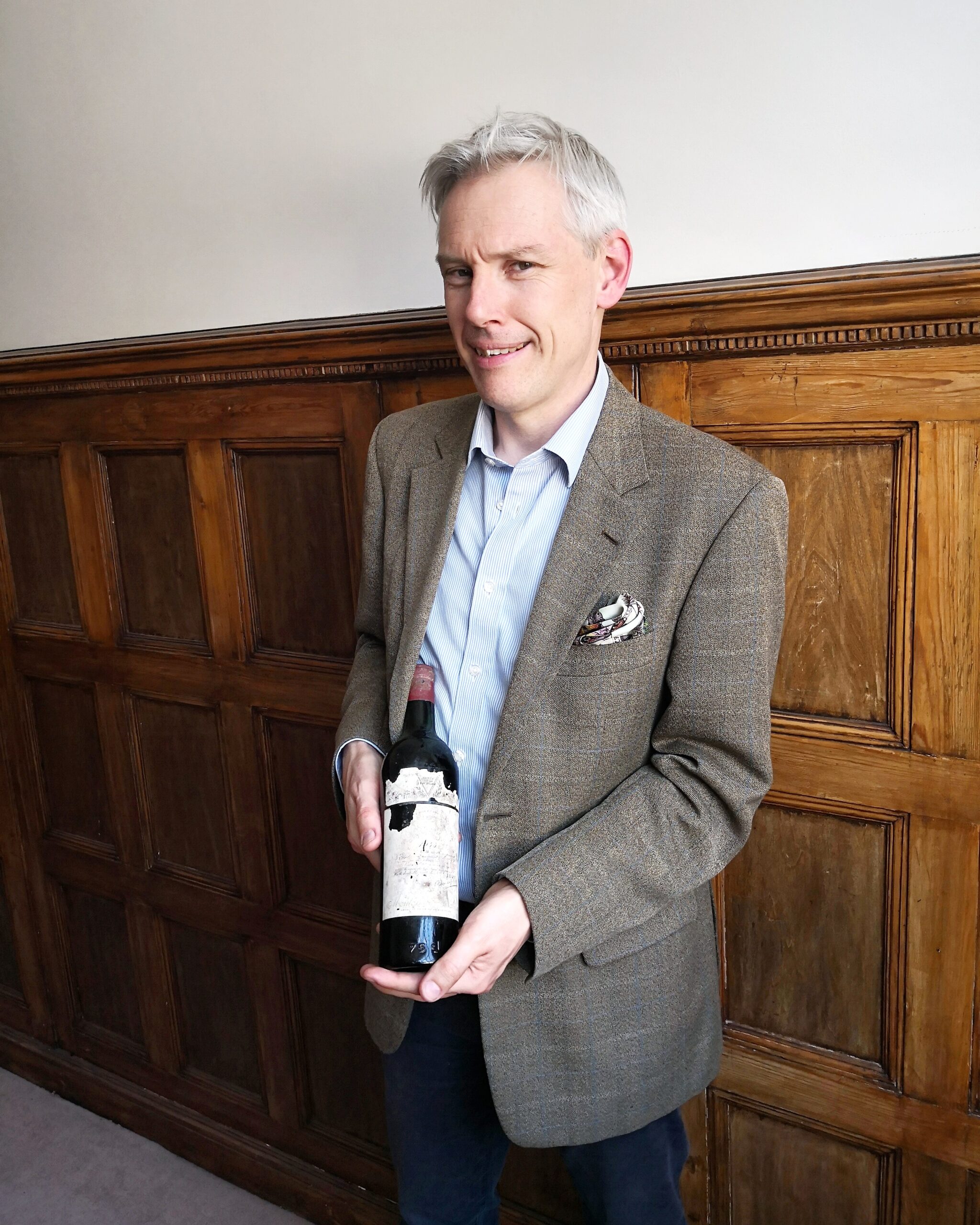 Stuart George with a bottle of Château Mouton Rothschild 1945